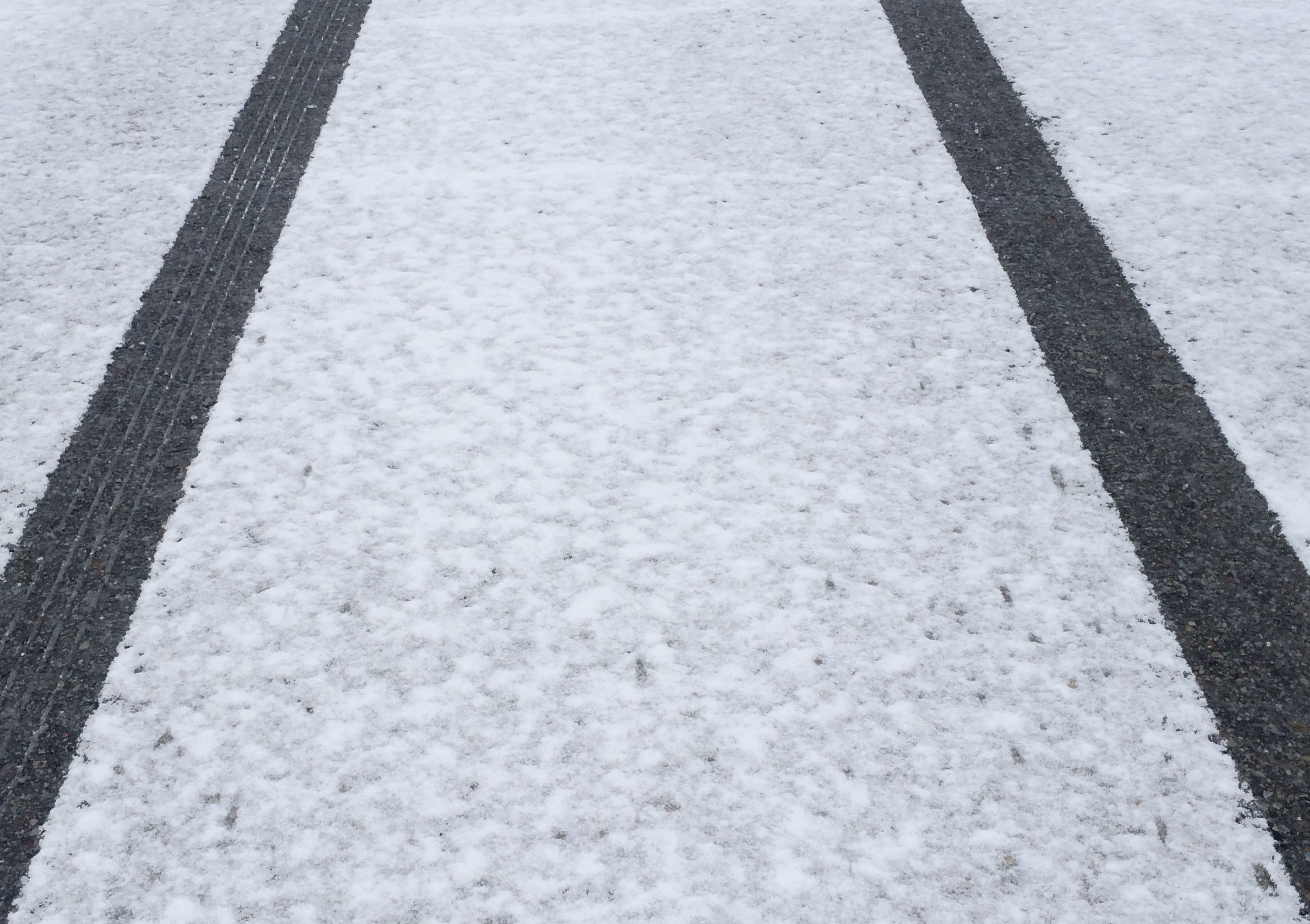 Tire tracks on a snowy road.